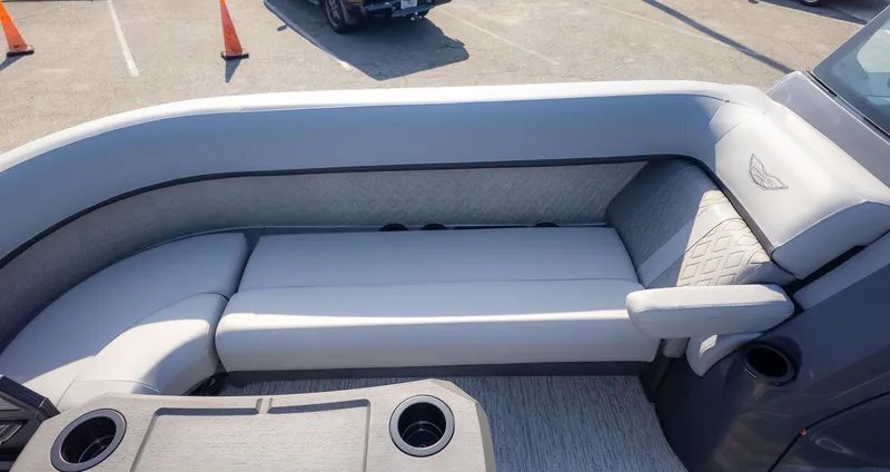 Slide: The Image of The image shows a luxurious gray seating lounge on a boat with cup holders. - 15