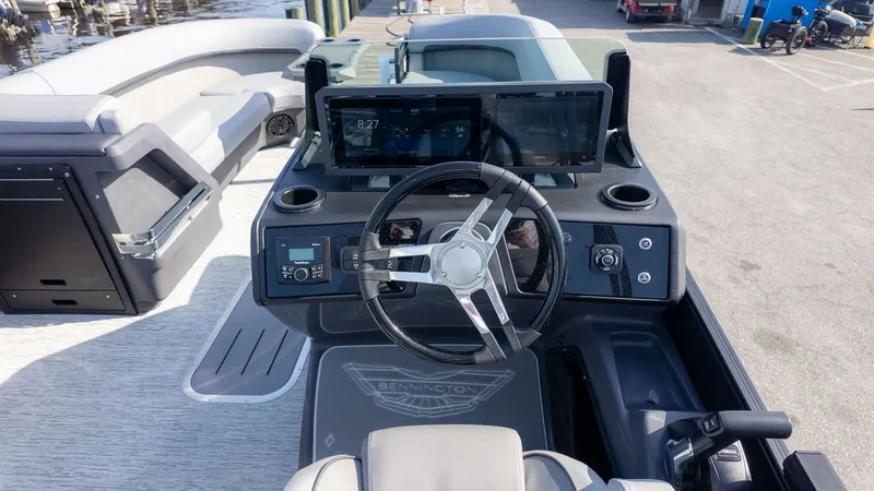 Slide: The Image of The image shows the helm of a 2026 Bennington 24 M Stern Lounge boat. - 22