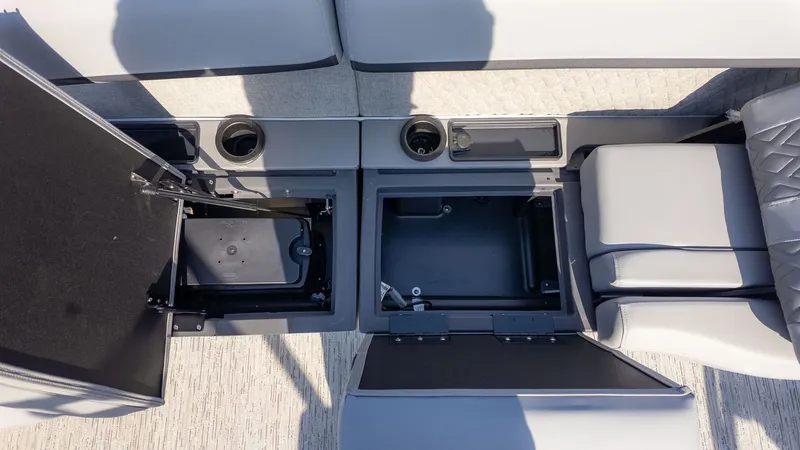 Slide: The Image of Interior view of a Bennington 24 M Stern Lounge boat with gray upholstery and storage compartments. - 6