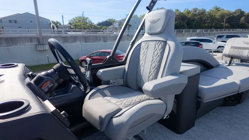 Slide: The Image of The image shows the helm of a Bennington 24 M Stern Lounge boat with a luxurious seat. - 18