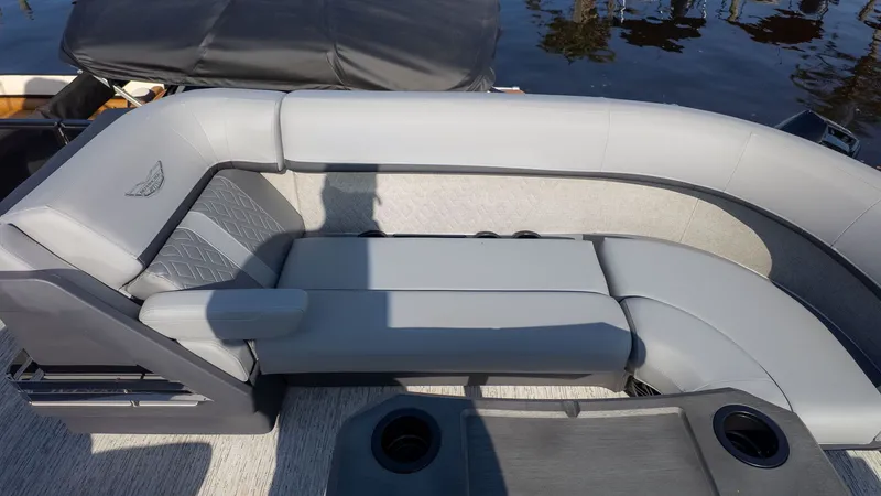Slide: The Image of The image shows a luxurious gray seating lounge on a boat by the water. - 12