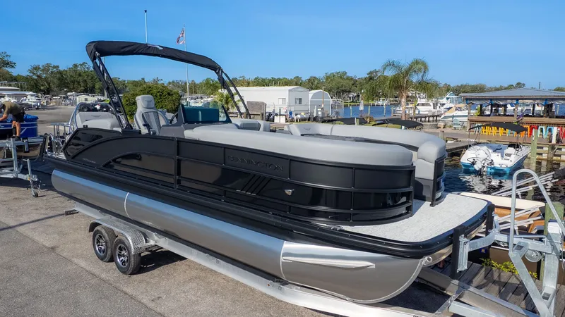 The Image of 2026 Bennington 24 M Stern Lounge on a trailer at a marina. - 1