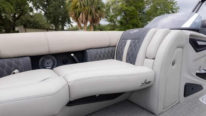 Slide: The Image of The image shows the luxurious interior of a Barletta Lusso 23U boat with elegant seating. - 24