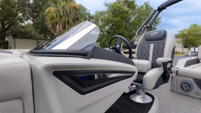 Slide: The Image of The image shows the cockpit of a Barletta Lusso 23U boat with a sleek seat and steering wheel. - 27