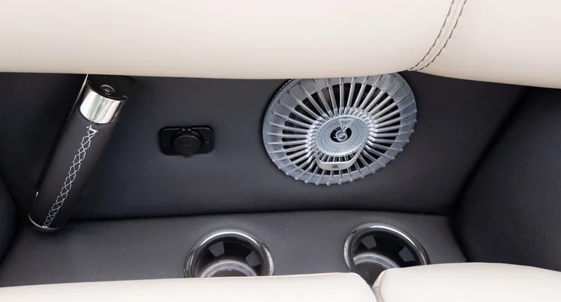 Slide: The Image of Close-up of a boat seat with a fan and cup holders. - 23