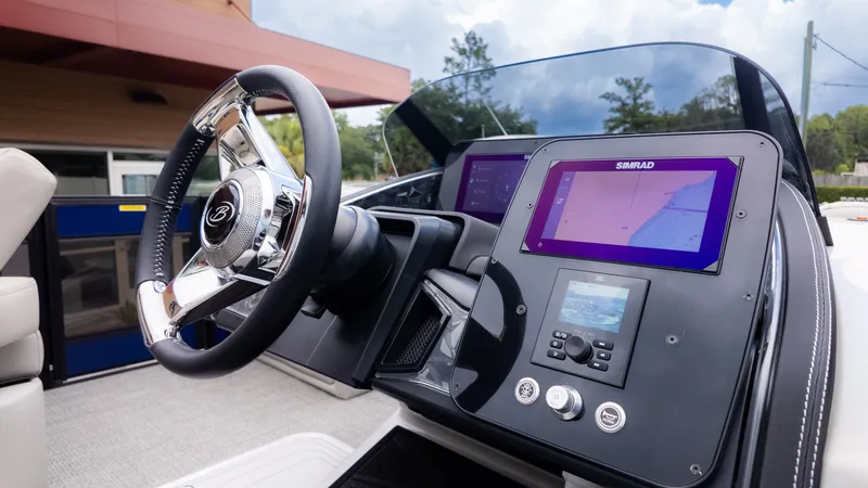 Slide: The Image of The image shows the helm of a Barletta Lusso 23U boat with modern navigation systems. - 29