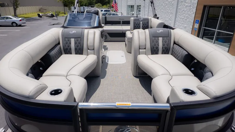Slide: The Image of The image shows the spacious deck of a Barletta Lusso 23U pontoon boat with luxurious seating. - 3