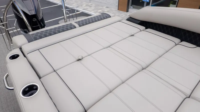 Slide: The Image of The image shows the lounge seating of a Barletta Lusso 23U boat. - 12