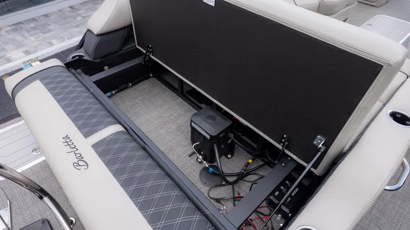 Slide: The Image of The image shows the seating area of a Barletta Lusso 23U boat with storage underneath. - 12