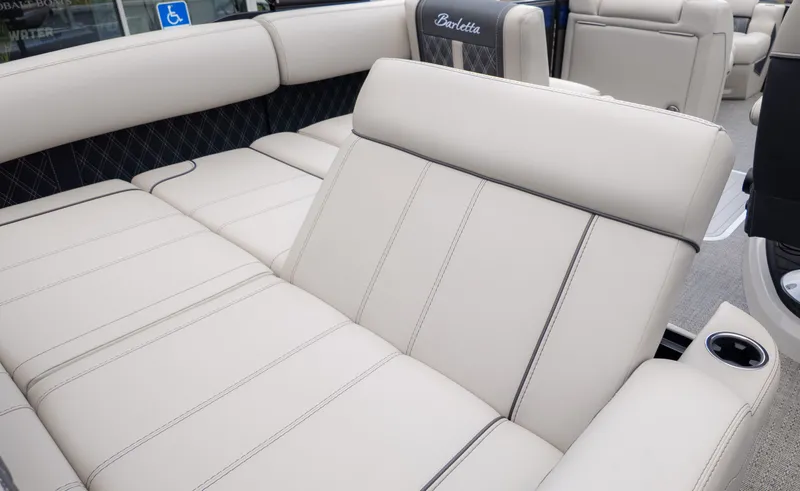 Slide: The Image of Luxurious cream-colored seating with black accents on a Barletta Lusso 23U boat. - 15