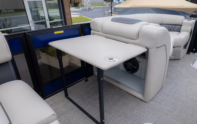 Slide: The Image of Interior of a Barletta Lusso 23U with beige upholstered seating and a foldable table. - 10
