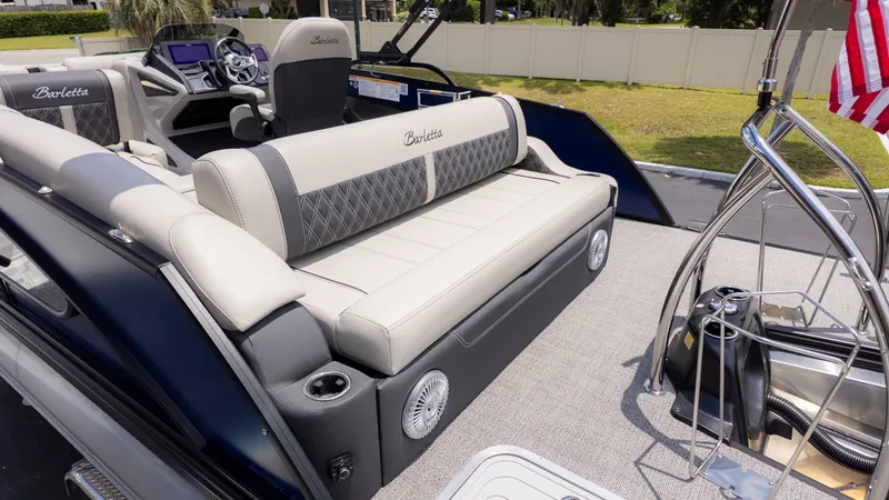 Slide: The Image of The image shows the deck of a Barletta Lusso 23U boat with elegant seating and a helm station. - 6