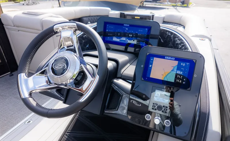 Slide: The Image of The image shows the cockpit of a 2026 Barletta Lusso L23M with modern navigation systems. - 24