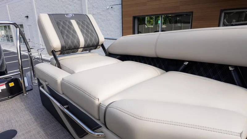 Slide: The Image of Luxurious cream-colored upholstery on a modern boat seat with sleek stitching and metal accents. - 13