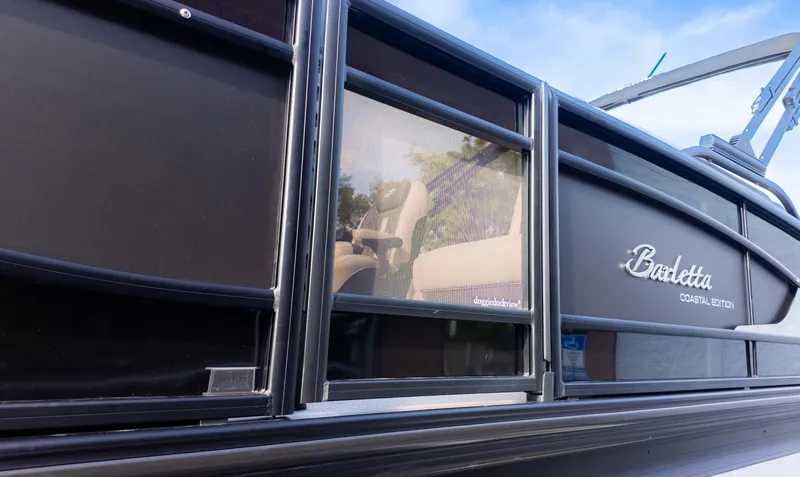 Slide: The Image of Close-up of Barletta Lusso L23M with dark hull and Coastal Edition logo. - 3