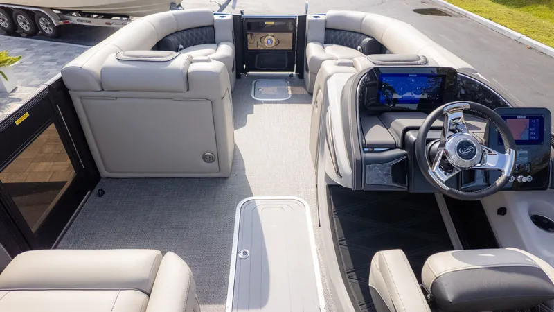 Slide: The Image of The image shows the interior of a 2026 Barletta Lusso L23M boat with luxurious seating and a modern helm. - 7