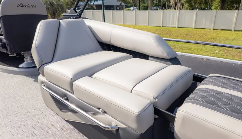 Slide: The Image of Luxurious cream-colored lounge seating on a Barletta Lusso L23M boat, surrounded by manicured lawn. - 10