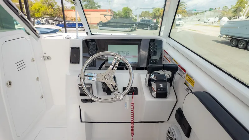 Slide: The Image of The image shows a boat's helm with a modern steering wheel and a large display screen. - 35