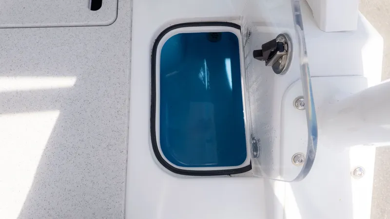 Slide: The Image of An open storage compartment on a boat with a blue interior and transparent lid. - 19