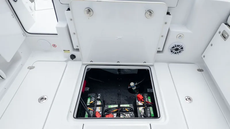 Slide: The Image of View of a boat's battery compartment with multiple batteries and cables. - 14