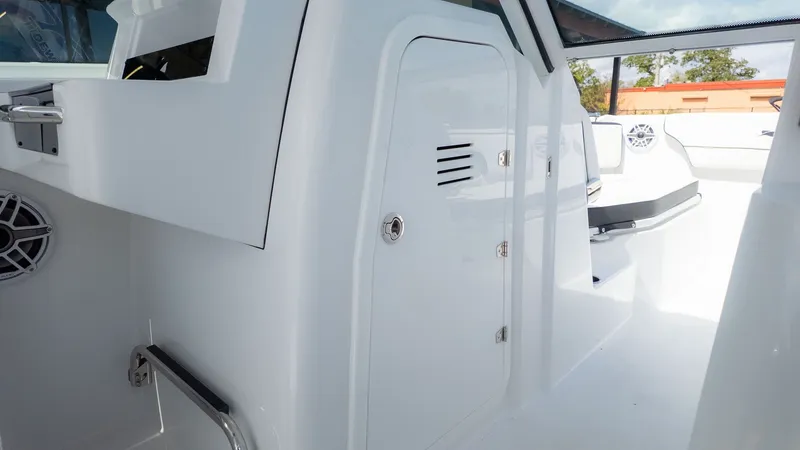 Slide: The Image of Interior view of a modern boat with white surfaces and an enclosed storage area. - 26