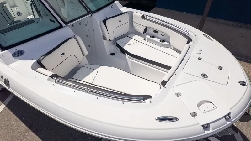 Slide: The Image of The image shows the cockpit of a 2026 Stingray 259 DC boat with white upholstery. - 7