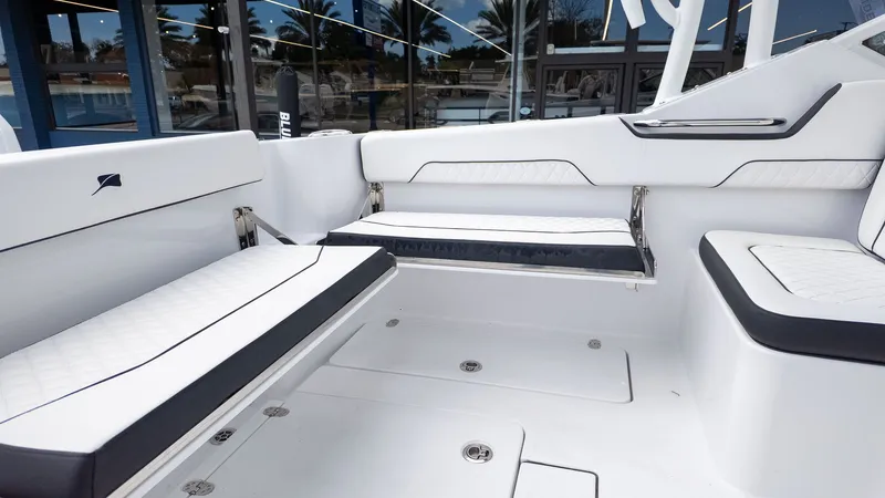 Slide: The Image of Interior of a modern boat with white upholstery and black accents. - 9