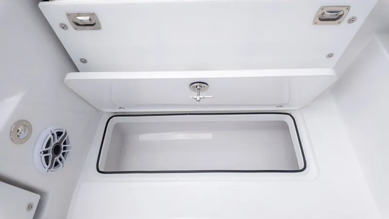 Slide: The Image of A white storage compartment with a lid and a speaker next to it. - 13