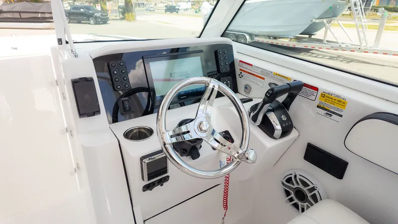 Slide: The Image of The cockpit of the 2026 Stingray 259 DC with modern steering and electronics. - 34