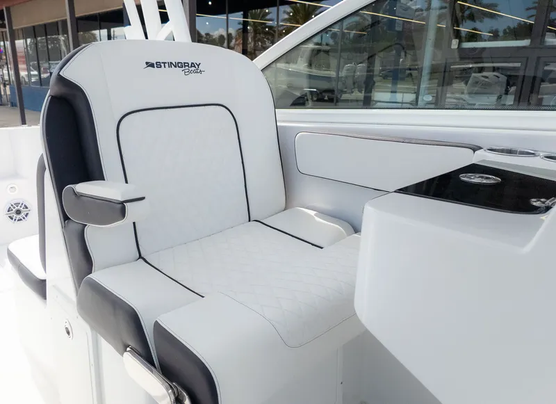 Slide: The Image of A sleek cockpit seat in a Stingray 259 DC boat, featuring white upholstery with black accents. - 24