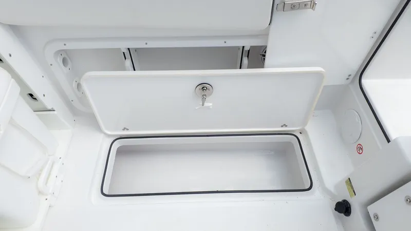Slide: The Image of An open storage compartment on a boat with a white interior. - 15