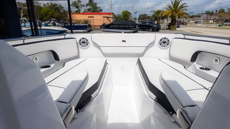 Slide: The Image of The image shows the cockpit of a Stingray 259 DC boat with white upholstery. - 27