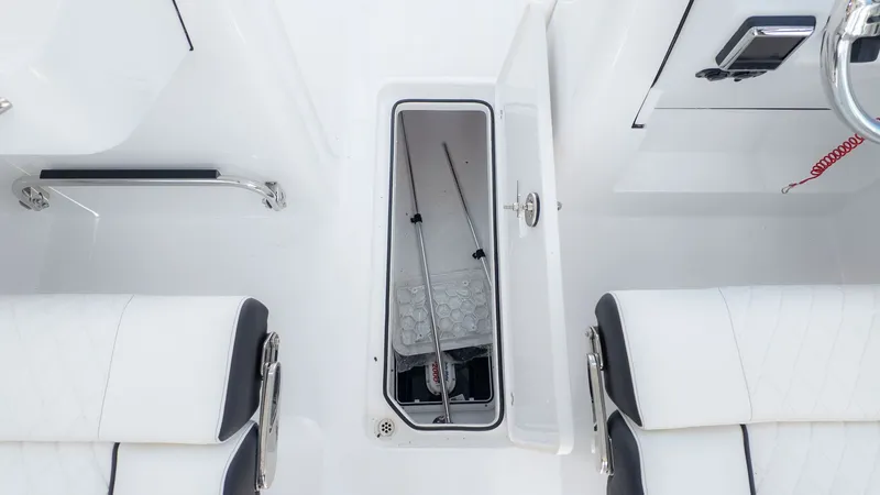 Slide: The Image of The image shows a boat interior with white seats and an open storage compartment. - 23