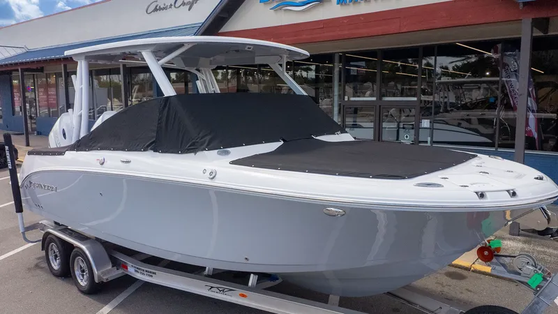 Slide: The Image of Stingray 259 DC 2026: Sleek design, parked on a trailer in front of a store. - 36