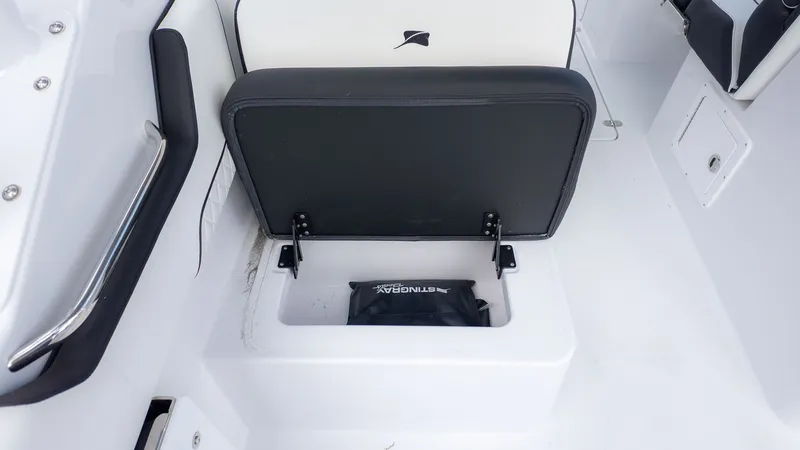 Slide: The Image of A seat on a boat with an open storage compartment underneath. - 16
