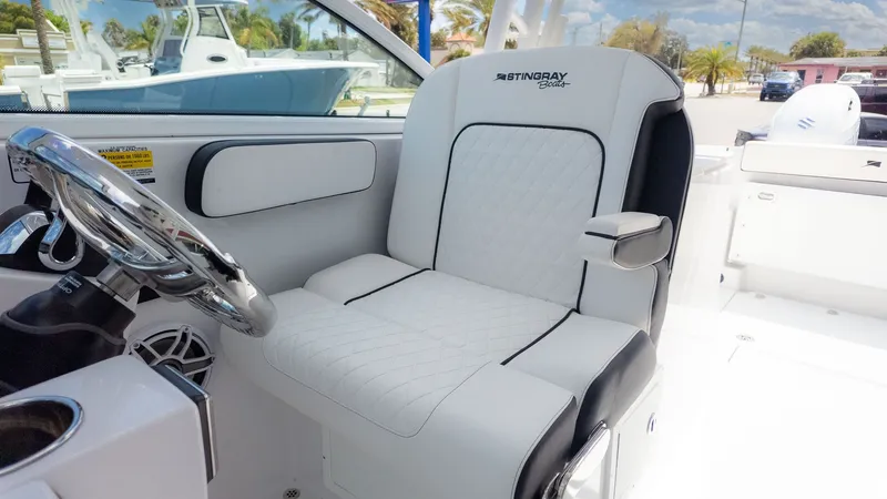 Slide: The Image of The Stingray 259 DC seat is white with black accents and armrests. - 31