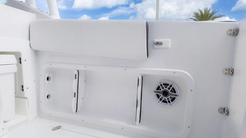 Slide: The Image of Interior view of a boat with white upholstery and speaker. - 14