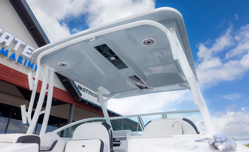 Slide: The Image of The image shows the cockpit of a Stingray 259 DC boat with a modern hardtop. - 35