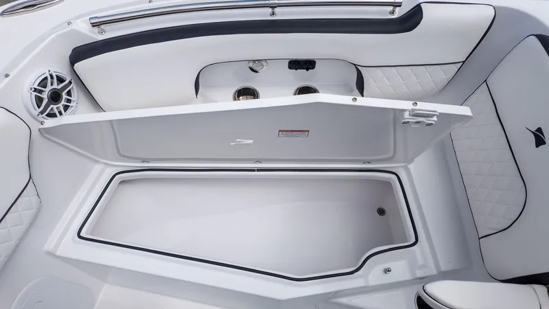 Slide: The Image of Stingray 259 DC 2026: White storage compartment with cushioned seating and speaker. - 28