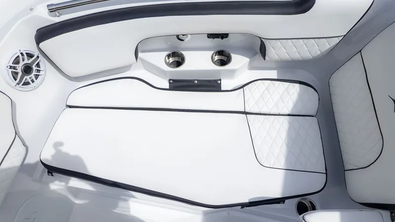 Slide: The Image of Interior view of a modern boat with white upholstery and speakers. - 29