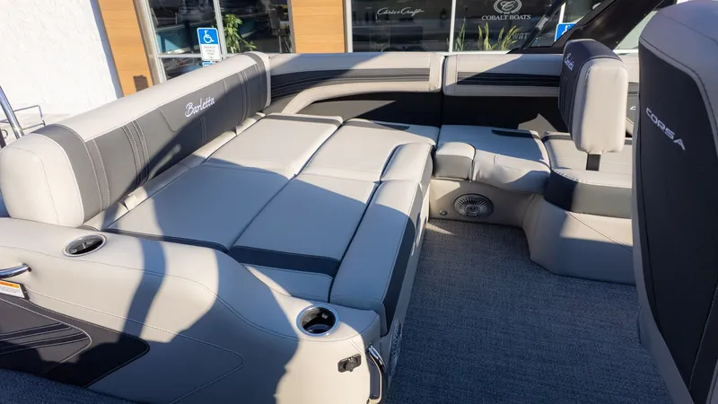 Slide: The Image of The image shows the interior of a Barletta Corsa X23U boat with gray upholstery and cup holders. - 11