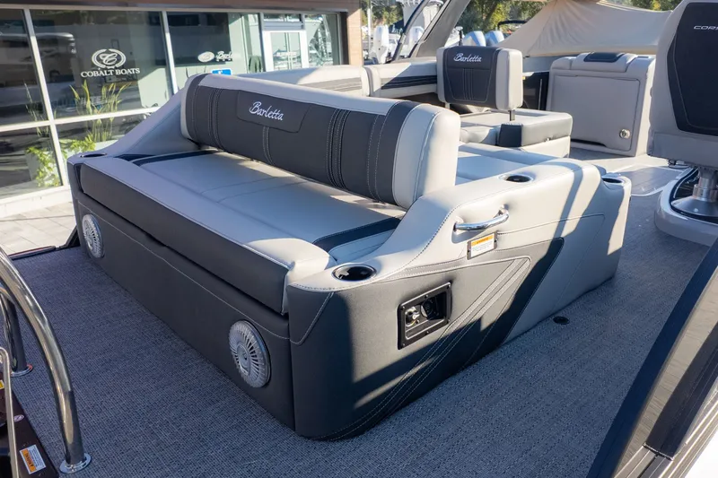 Slide: The Image of The image shows a gray seating area on a boat with cup holders and speakers. - 7
