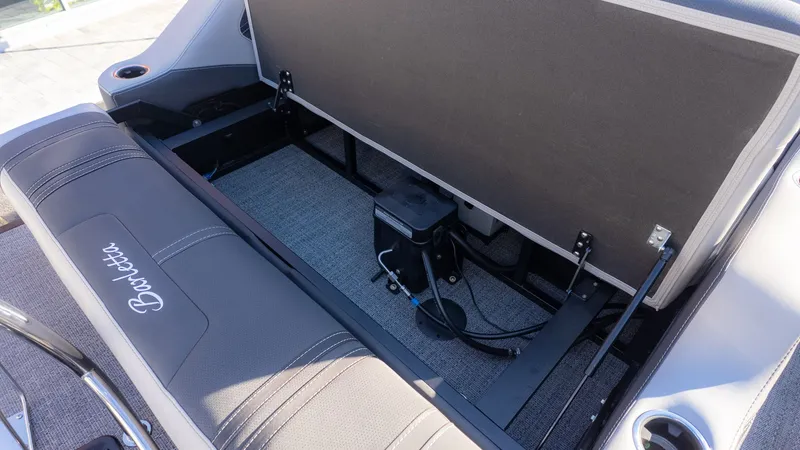 Slide: The Image of The image shows the storage space under a seat on a Barletta Corsa X23U boat. - 8