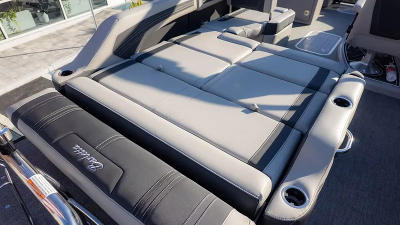 Slide: The Image of The image shows the lounge seating of a Barletta Corsa X23U boat with gray and black upholstery. - 8