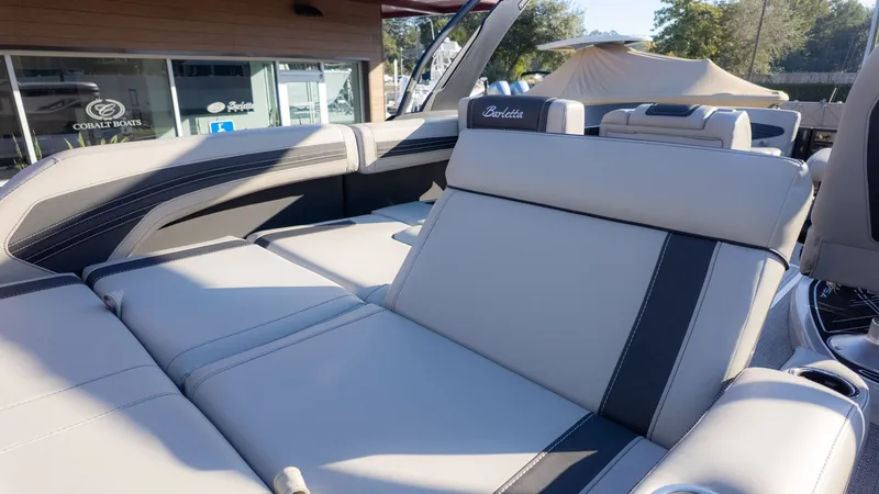 Slide: The Image of The image shows the luxurious interior of a Barletta Corsa X23U boat with beige upholstery. - 9