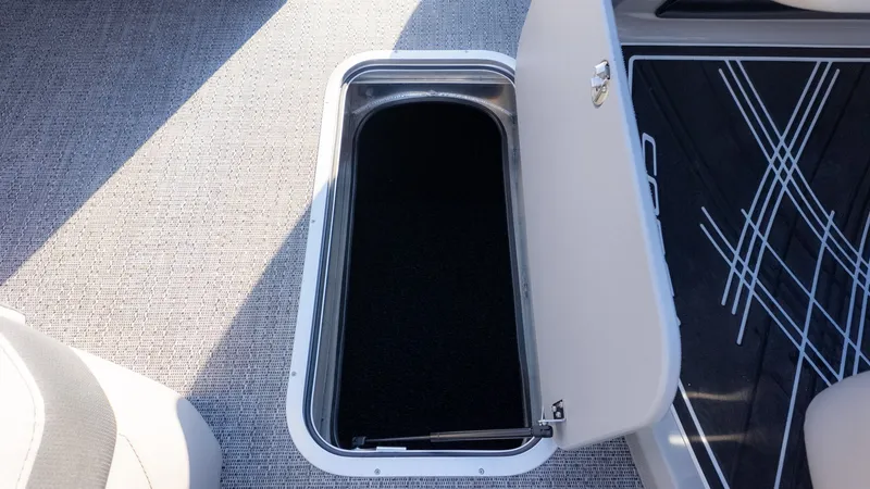 Slide: The Image of An open storage compartment on a boat with carpeted flooring and modern details. - 13