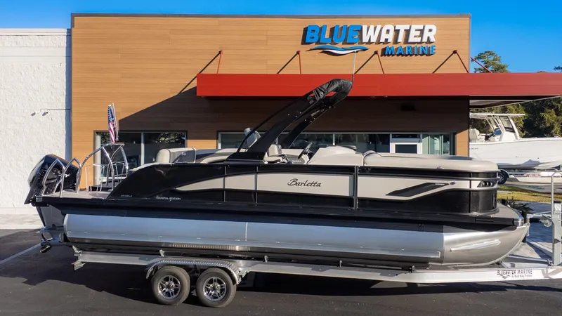 Slide: The Image of 2026 Barletta Corsa X23U in front of a building with Blue Water Marine logo. - 25