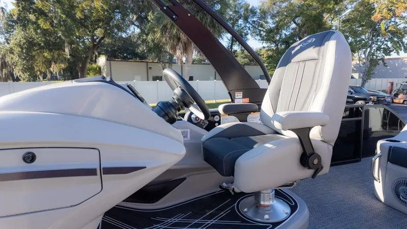 Slide: The Image of The image shows the helm of a Barletta Corsa X23U boat with a cushioned seat. - 21
