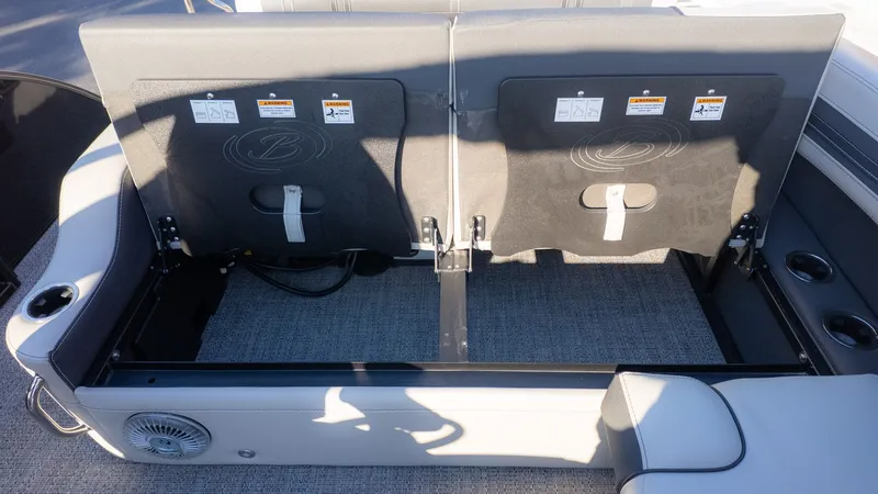 Slide: The Image of Rear view of a boat seat with gray upholstery and safety straps. - 10