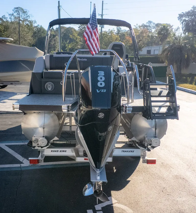 Slide: The Image of The image shows a Barletta Corsa X23U pontoon boat with a Mercury 300 V8 outboard motor. - 4